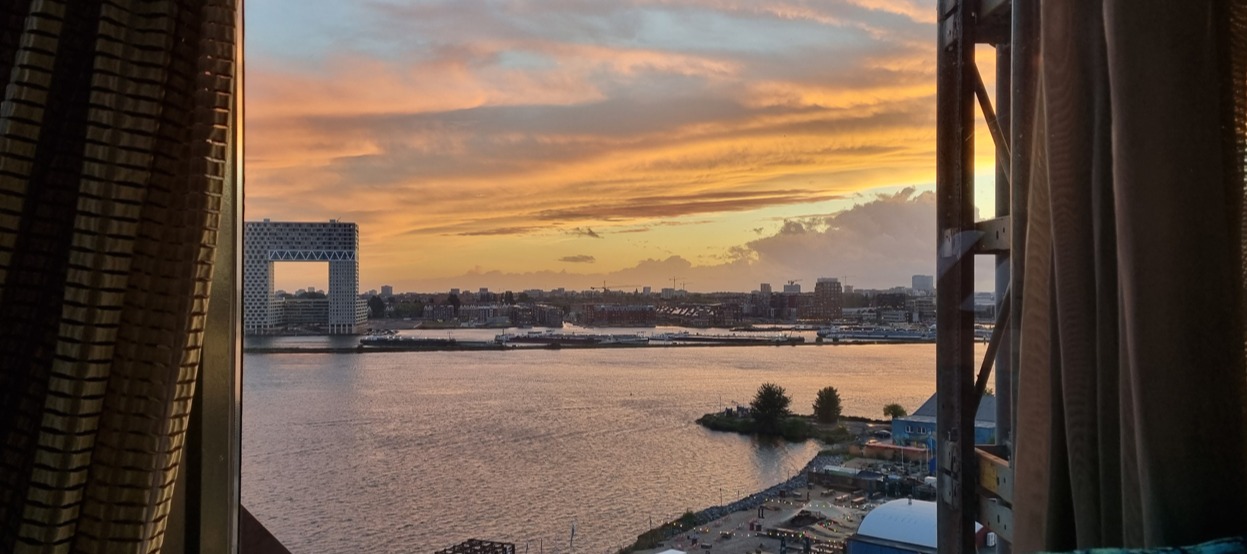 Sunset view from Faralda Crane Hotel, overlooking the IJ River and Pontsteiger building in Amsterdam.